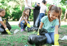 children picking up trash in a park