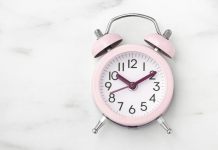 pink clock on a marble background