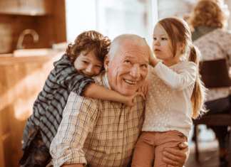 Grandfather hugging grandkids