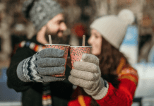 man and women dressed in winter clothes drinking hot chocolate