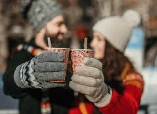 man and women dressed in winter clothes drinking hot chocolate