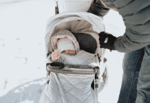 child bundled up in stroller in winter