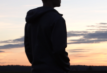 silhouette of teenage boy at sunset